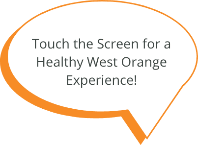 Speech bubble with message saying touch the screen for a Healthy West Orange experience.